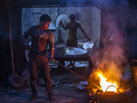 Labourers melts brass at a dockyard in Keraniganj on October 2, 2021. (