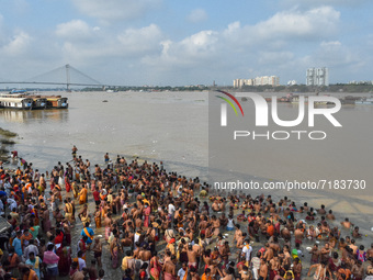 Hindu devotees are seen crowding a Ganges riverside to offer prayers during Mahalaya , following no social distance protocol , in Kolkata ,...