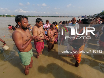 Hindu devotees are seen offering prayer at a Ganges riverside , during Mahalaya in Kolkata , India , on 6 October 2021 .Mahalaya is a Hindu...