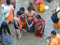 Hindu devotees are seen offering prayer at a Ganges riverside , during Mahalaya in Kolkata , India , on 6 October 2021 .Mahalaya is a Hindu...