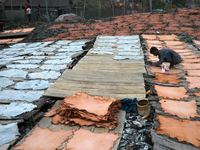A worker sets up leather pieces on a rack to make it dry at a tannery in Hazaribag, Dhaka, Bangladesh on October 06, 2021. Though many leath...