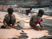 Child workers set up leather pieces on a rack to make it dry at a tannery in Hazaribag, Dhaka, Bangladesh on October 06, 2021. Though many l...