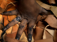 A worker pushes small leather pieces to sell in a shoe factory in Hazaribag, Dhaka, Bangladesh on October 06, 2021. Though many leather fact...