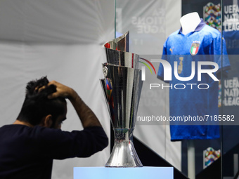 A visitor passes by the UEFA Nations League Trophy during UEFA Nations League Trophy Experience event in Milan, Italy on October 6, 2021. (