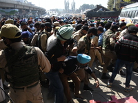 Sikh mourners remove the police roadblocks as they carry the dead body of the slain school principal Supinder Kaur in Srinagar, Indian Admin...