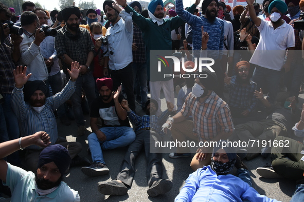 Sikh mourners protest outside the civil secretariat as they carry the dead body of the slain school principal Supinder Kaur in Srinagar, Ind...