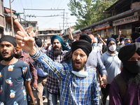 Sikh mourners shout slogans as they carry the dead body of the slain school principal Supinder Kaur in Srinagar, Indian Administered Kashmir...