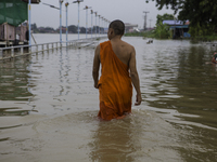 Oct 8, 2021, The monk walked through the flood to examine the depth of the water that overflowed into the temple's harbor area. (