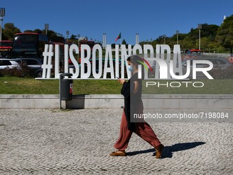 A woman wearing protective mask walks near the Eduardo VII square, Lisbon. 07 October 2021. Portugal has about nine million people vaccinate...