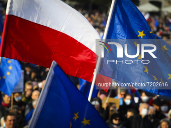 EU and Polish national flags are seen during 'We're staying in EU' demonstration at the Main Square in Krakow, Poland on October 10, 2021. T...