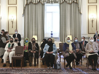 Afghan women, part of a group of lawyers and judges who fled Afghanistan following the Taliban takeover, at the presidential mansion, during...