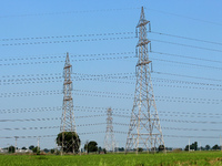 High-tension power lines are pictured in a field, on the outskirts of New Delhi, India on October 11, 2021. Over half of India's 135 coal-fi...