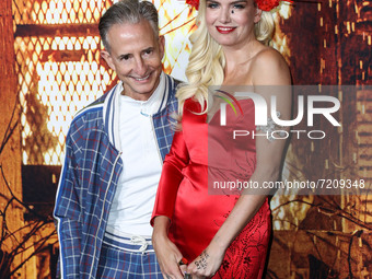 CEO of Miramax Bill Block and Eugenia Kuzmina arrive at the Costume Party Premiere Of Universal Pictures' 'Halloween Kills' held at the TCL...