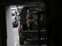 Armed soldiers in a military vehicle patrol the street in Yangon, Myanmar on October 13, 2021.  (
