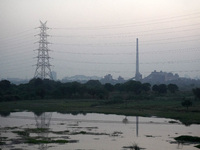An electricity pylon carrying high tension wires is seen in front of a decommissioned coal-fired power plant in New Delhi, India on October...