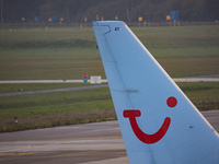 Logo of TUI on the vertical stabilizer of the plane. TUI Airlines Belgium Boeing 737-800 aircraft as seen flying, landing and taxiing at Ein...