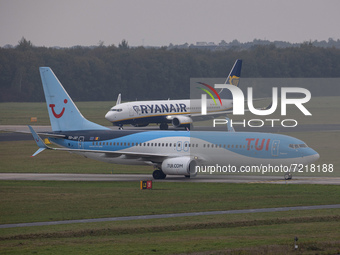 A TUI and a Ryanair Boeing 737 aircraft taxiing. TUI Airlines Belgium Boeing 737-800 aircraft as seen flying, landing and taxiing at Eindhov...