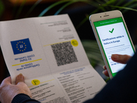 A worker checking green pass certificate in L'Aquila, Italy, on October 15, 2021. On October 15 green card certification becomes mandatory f...