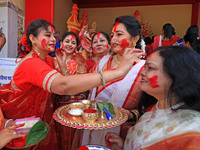 Jaipur: Married women apply vermilion on each other's faces during 'Sindoor Khela' before the immersion of Goddess Durga on the last day of...