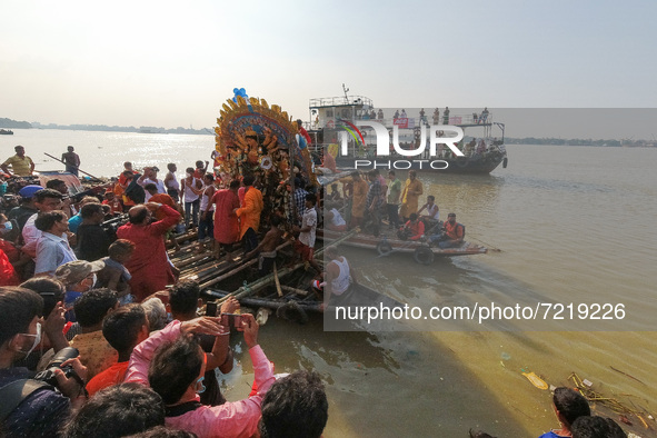 An idol of Durga is seen ferried to deep parts of Ganges river for immersion , on the last day of Durga puja festival in Kolkata , India , o...