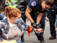 A protester is arrested at the US Capitol during a youth-led civil disobedience action by indigenous American and allies.  The protest again...