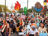 Native American climate activists and allies, many under the age of 18, await arrest at the US Capitol during a youth-led civil disobedience...