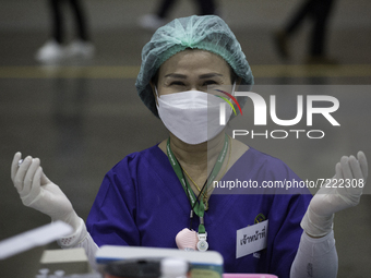 Medical personnel shaking the Pfizer vaccine before it is inserted into syringes in Nonthaburi province at Hall 5, Impact Arena, Muang Thong...