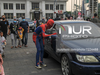A cosplayer dressed as Spider-Man is seen entertaining the tourist on October 16, 2021 in Asia Afrika Street, Bandung, West Java, Indonesia....