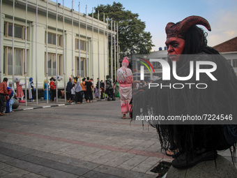 A cosplayer dressed as ghost is seen near Gedung Merdeka Tourism Area on October 16, 2021 in Asia Afrika Street, Bandung, West Java, Indones...