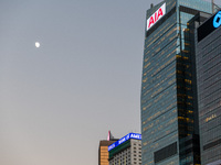  The moon rises as the building of AIA stands in Central Hong Kong. (