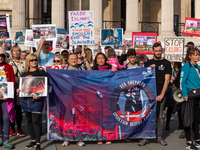 Demonstrators gather at the Trafalgar Square holding placards and banners to protest slaughtering of hundreds of dolphins in Faroe Islands -...