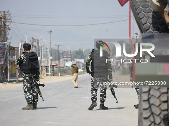 Indian paramilitary troopers stand alert on a deserted street during a gun battle between Indian Forces and militants in Pampore area of Pul...
