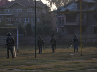 Indian paramilitary troopers chase people during a gun battle between Indian Forces and militants in Pampore area of Pulwama district south...