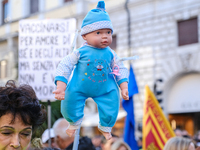 a doll pierced by syringes as a symbol of protest against the vaccine for children.
No Vax and No Green Pass protesters protested in Padua,...
