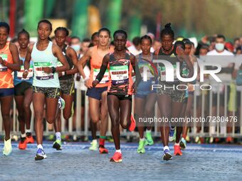 Ethiopia's Tigist Memuye (R), winner in women's race, takes the start of the 42,195 km Paris Marathon, as part of its 45th edition on the Ch...