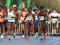 Ethiopia's Tigist Memuye (R), winner in women's race, takes the start of the 42,195 km Paris Marathon, as part of its 45th edition on the Ch...