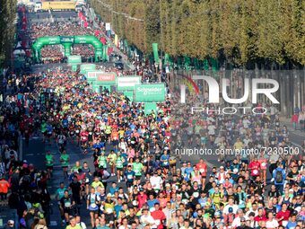 Runners compete on the Champs-Elysees avenue in the 42,195 km Paris Marathon, as part of its 45th edition on October 17, 2021. (