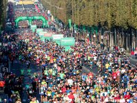 Runners compete on the Champs-Elysees avenue in the 42,195 km Paris Marathon, as part of its 45th edition on October 17, 2021. (