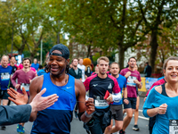 A runner is giving high five to a man watching the run, during the TCS Amsterdam marathon, on October 17th, 2021. (
