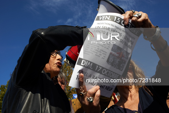 A woman reads a text about the slaughter. Dozens of protesters walk to commerorate the 60th anniversary of the slaughter of algerian protest...
