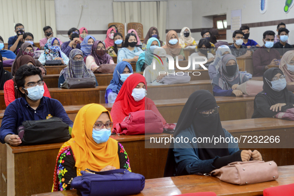 Dhaka University students wearing face masks attend their class after one and half year reopened maintaining Covid-19 guidelines and health...