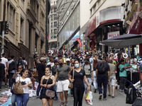 People walk in the commercial center of Sao Paulo, Brazil, on October 18, 2021 amid the Covid-19 pandemic. (