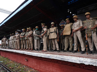 Policemen stand guard as farmers block railway tracks during a nationwide rail blockade demanding dismissal of Union Minister Ajay Mishra, d...