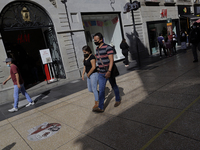 Passers-by on Madero Street in the Historic Centre of Mexico City, during the COVID-19 emergency and the official return to green epidemiolo...