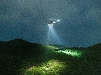 An airbus helicopter of the Government Flying Services illuminates Kowloon Peak with projectors to find lost hiker, in Hong Kong, China, on...