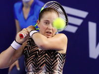 Jelena Ostapenko of Latvia returns the ball to Andrea Petkovic of Germany during the women's singles Round of 32 tennis match of the WTA 500...