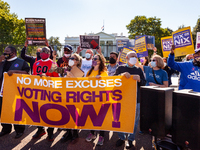 Voting rights activists hold a brief rally before a civil disobedience action at the White House.  Demonstrators are demanding that the Bide...