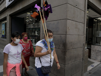 A woman holds up a rehilete in the streets of Mexico City's Historic Centre, during the COVID-19 emergency and the official return to the gr...