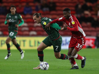   Isaiah Jones of Middlesbrough battles with Barnsley's Callum Brittain during the Sky Bet Championship match between Middlesbrough and Barn...