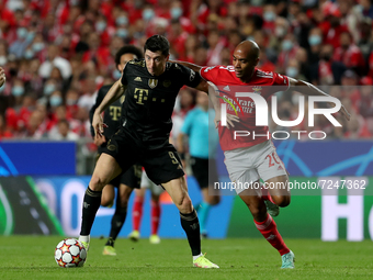 Robert Lewandowski of Bayern Muenchen (L) vies with Joao Mario of SL Benfica during the UEFA Champions League group E football match between...